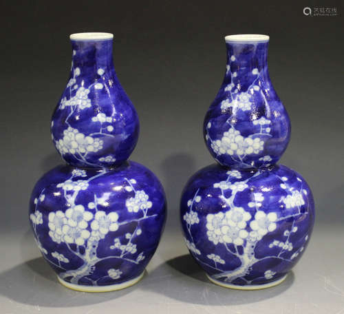 A pair of Chinese blue and white porcelain gourd vases, mark of Kangxi but modern, each painted with