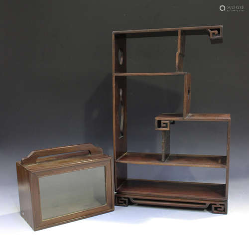 A Chinese hardwood display shelf, 20th century, with an arrangement of asymmetrical shelves on