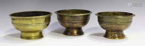 A pair of Indian brass circular bowls, 18th/19th century, each exterior engraved with foliate