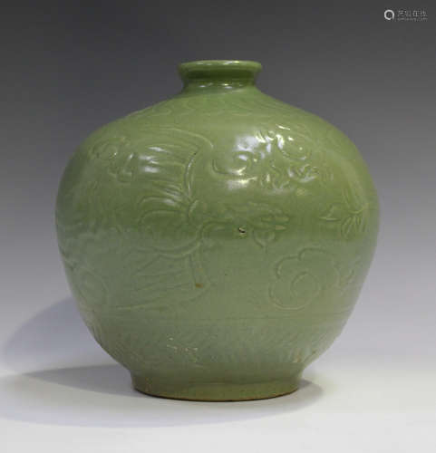 A Chinese celadon glazed vase, Ming style but probably Qing dynasty, of stout ovoid form, carved