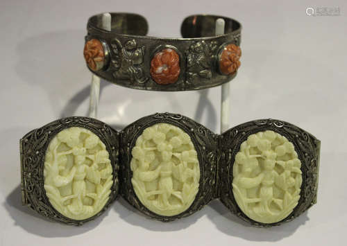 A Chinese silver and coral bangle, 20th century, decorated in relief with figures and landscapes,