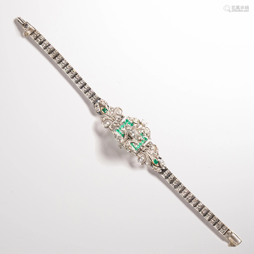 A diamond, emerald and fourteen karat gold strap