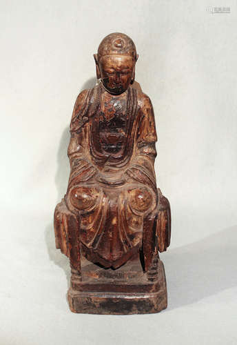 A Chinese carved and polychrome painted wood figure of a seated Buddha,