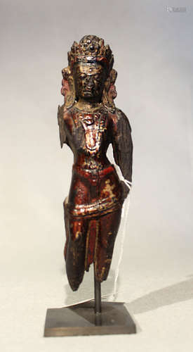 A Tibetan carved, painted, and lacquered wood Tara fragment, possibly 17th century,