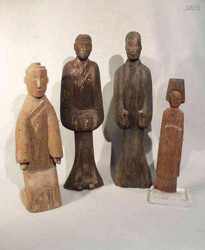 A group of four Chinese carved and painted wood standing figures, in Han Dynasty style,