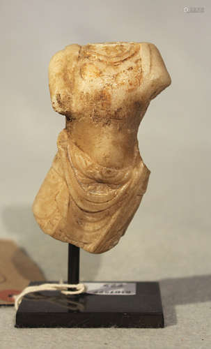 A Chinese white marble fragmentary Buddhist deity torso, in 6-7th century style,