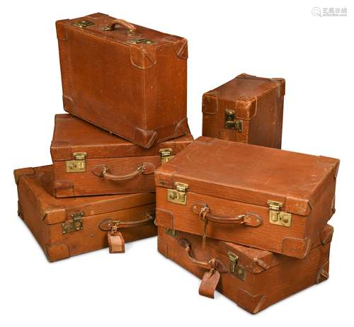 A set of early 20th century leather luggage,