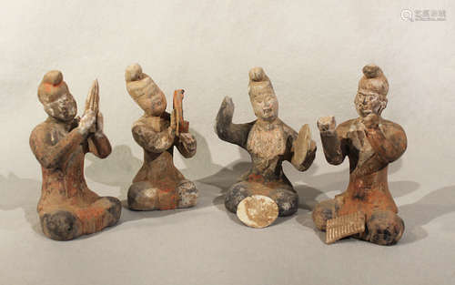 A group of four Chinese painted pottery seated musicians, perhaps Tang Dynasty,