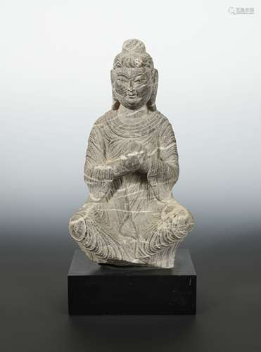 A Chinese white banded grey stone figure of a Seated Buddha, in Wei Dynasty style,