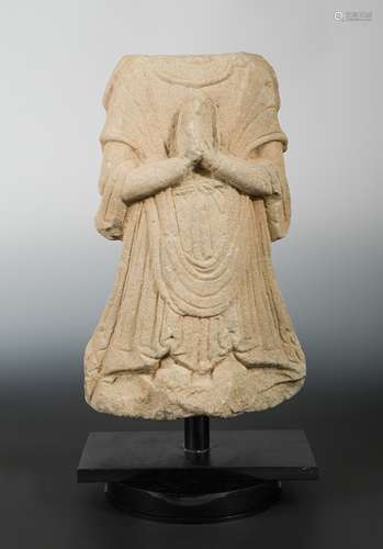 A Chinese carved sandstone robed torso of a Buddhist deity, in Tang Dynasty style,