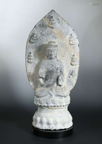 A Chinese grey stone figure of a seated Buddha, in Wei Dynasty style,