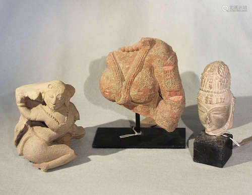 A group of three Indian pink and cream coloured stone Shiva fragments, 13th/14th century style,