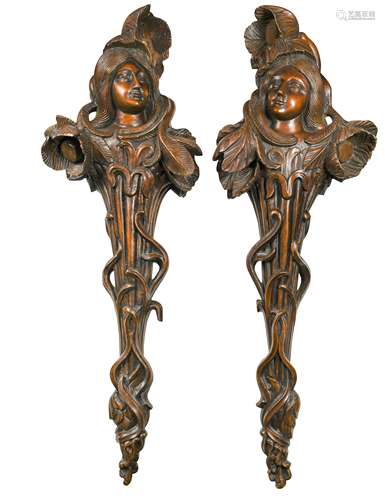 A pair of carved walnut Art Nouveau wall brackets,