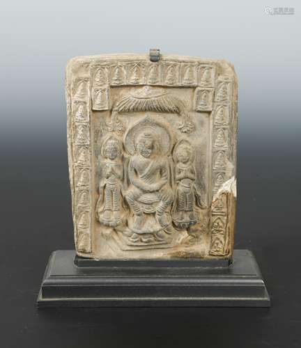 A Chinese grey clay tile depicting a Buddha triad, in Northern Wei style,