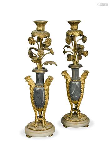 A pair of 19th French gilt bronze and marble candlesticks,