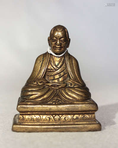 A Tibetan gilt bronze seated Monk, 19th century or possibly earlier,