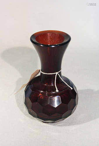 A Chinese Pekin glass dark amber vase with trumpet neck and faceted body,