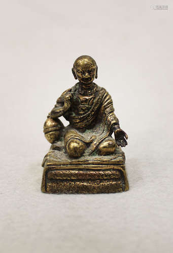 A Sino-Tibetan Silvered bronze small seated figure of a Monk, circa 1800,