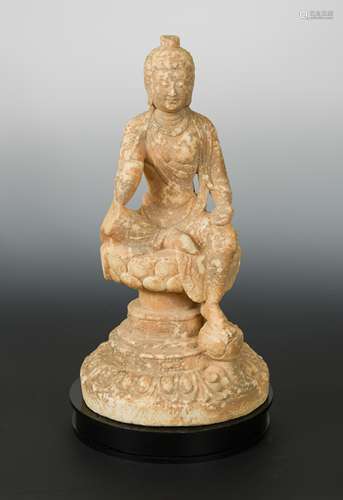 A Chinese white marble Buddhist deity, in Northern Wei style, on a dais,