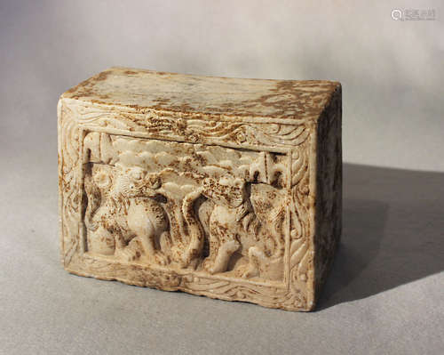 A Chinese white marble pillow or stand in relief with mythical animals, in Wei Dynasty style,