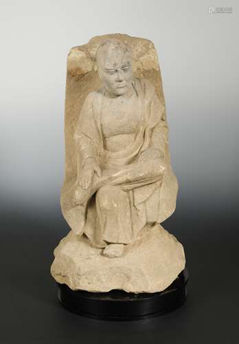 A Chinese sandstone figure of a seated Monk, in Tang Dynasty Style