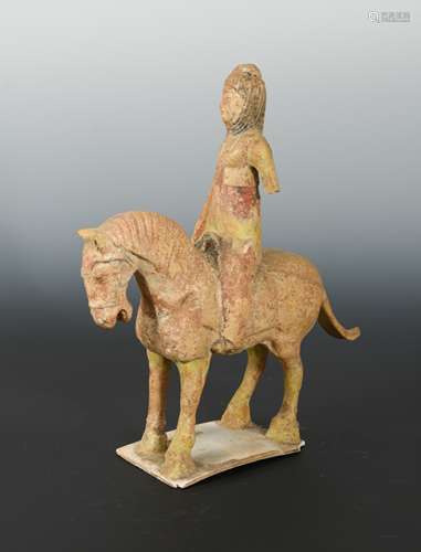 A Chinese painted pottery horse with Middle Eastern lady rider up, in Tang Style,