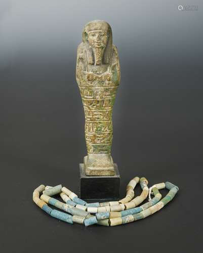 An Egyptian faience shabti figure, impressed with hieroglyphics,