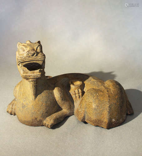 A Chinese grey limestone figure of a recumbent Pixiu/Chimera, in Southern Qi style,