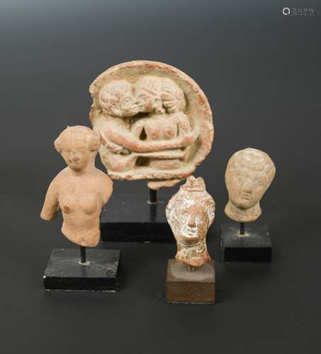 Four Greek pottery fragmentary heads of male and females,