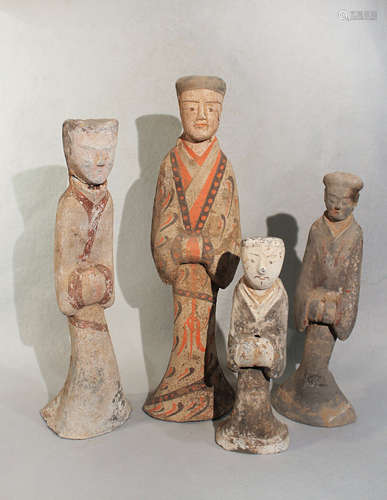 A group of four Chinese painted pottery standing male and female attendants, perhaps Han Dynasty,