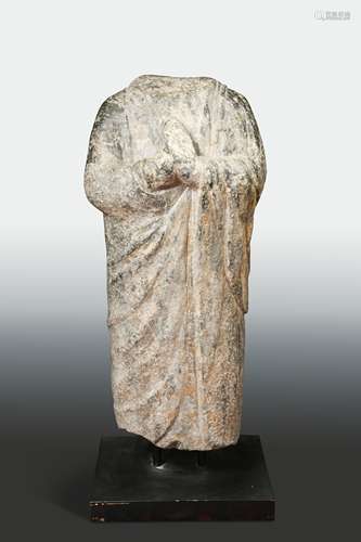 A Chinese limestone standing figure of an enrobed Buddhist figure, in Wei Dynasty style,