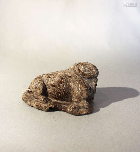 A Chinese brown mottled stone recumbent figure of a cloven mythical creature, in Sui Dynasty style,