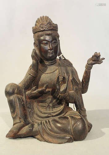 A Chinese carved wood figure of the four-armed seated Bodhisattva Guanyin, 20th century,