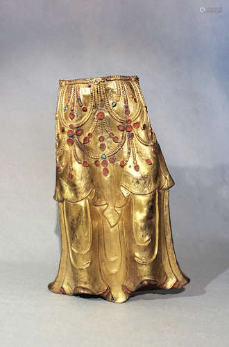 A Tibetan gilt-copper lower torso fragment of a deity, 18th century,