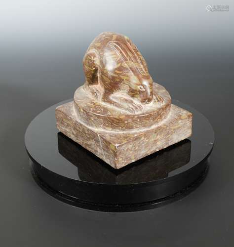 A Chinese red puddingstone crouched hare, in Sui Dynasty style,