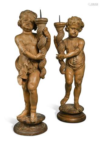 A pair of carved limewood pricket stands, probably 17th century,