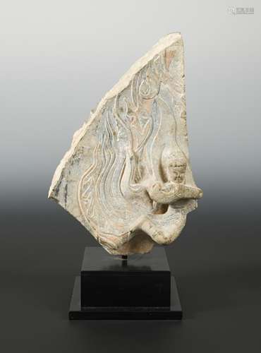 A Chinese limestone stele fragment carved with apsaras, in Wei Dynasty style,