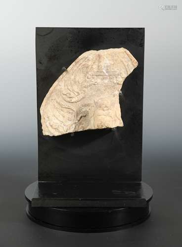 A Chinese white marble aureole fragment with head of a Buddhist deity and apsara,