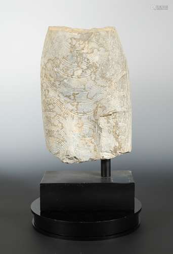 A Chinese limestone carved mid-torso fragment of a Buddha, in Wei Dynasty style,