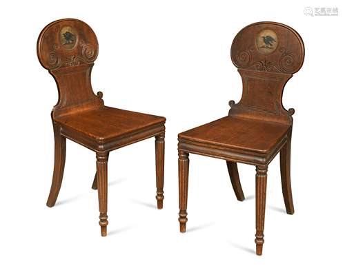 A pair of Regency oak hall chairs,