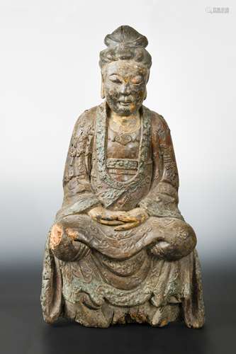 A Chinese carved and polychrome wood seated figure of Guanyin, perhaps late Ming Dynasty,