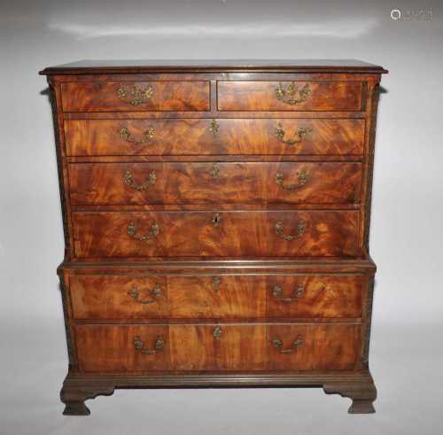 A good mid-18th century figured mahogany veneered chest on chest, with blind fretwork canted
