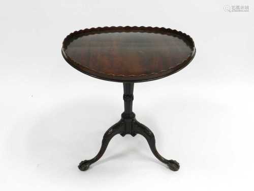 A George II style mahogany tripod table, 19th Century, the circular top with an undulating