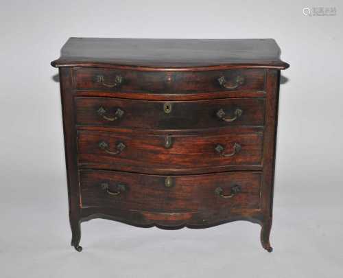 A George III, French Hepplewhite style mahogany veneered, serpentine 4-drawer commode, the moulded