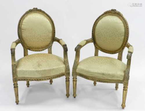 A pair of Louis XV style carved giltwood open armchairs