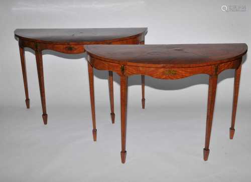 A pair of 19th century, Neoclassical style, demi-lune, satinwood console tables, painted in the