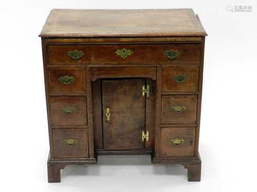 A George II walnut veneered dressing chest, the rectangular top 1/4 veneered and inlaid with feather