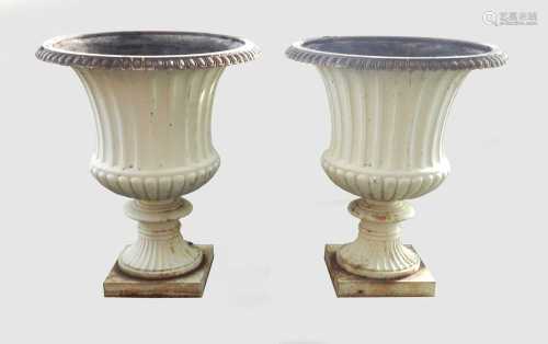 A pair of large cast iron garden urns, 19th/20th century