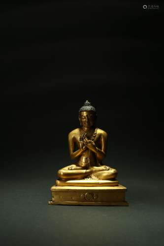 A good Tibetan gilt copper alloy figure of Shakyamuni Buddha, 15th century