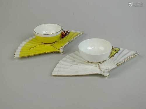 A pair of John Mortlock for Samuel Moore butterfly-handled cups with fan saucers